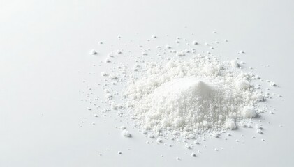 Scattered white sugar crystals on white surface, product photography, sweetener, culinary