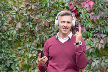 Music lifestyle. Man in headphones in autumn. Lifestyle concept. Mature man enjoy listening music...