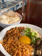 Delicious Bowl of Chicken Porridge with Creamy Egg Yolk Topping
