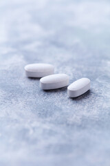 Amino acids tablets on wooden background. Soft focus. Close up	