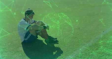 Female soccer player sitting on grass field, showing digital network overlay for sports technology - Powered by Adobe