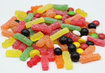 A group of hazelnuts with some cracked open showing the nut on a white background in a studio shot