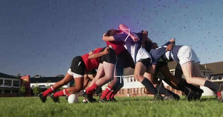 Male rugby players pushing over ball on sports field, showing neon purple and blue light overlays - Powered by Adobe