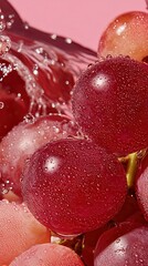 large view of an entire complete single bunch of red-pink grapes with glossy texture and water droplets, isolated on a soft pink studio background, luminous lighting, ultra.