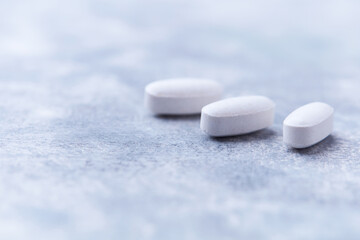 Amino acids tablets on wooden background. Soft focus. Close up	