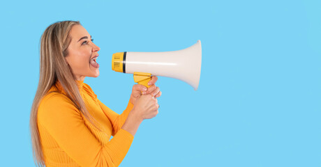 Woman enthusiastically using a megaphone to communicate important messages while wearing a bright yellow sweater against a blue background