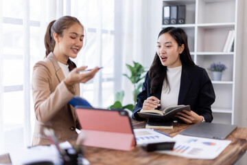 Asian company employees and colleagues work together in the office. Doing accounting analysis report real estate investment data, Financial and tax systems concept.
