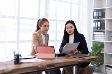 Asian company employees and colleagues work together in the office. Doing accounting analysis...