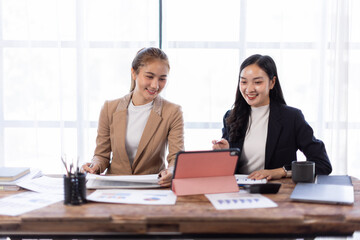 Asian company employees and colleagues work together in the office. Doing accounting analysis report real estate investment data, Financial and tax systems concept.

