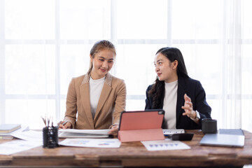 Asian company employees and colleagues work together in the office. Doing accounting analysis report real estate investment data, Financial and tax systems concept.
