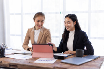 Asian company employees and colleagues work together in the office. Doing accounting analysis report real estate investment data, Financial and tax systems concept.
