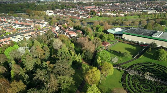 Wide, reversing aerial of Botanic Gardens in Belfast, County Antrim in Northern Ireland on a sunny day. Also in view are the River Lagan and Ormeau area. Filmed in 4K, 60FPS and in Rec709 Color.