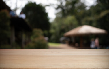 Empty wood table top and blur of restaurant background selective focus product display