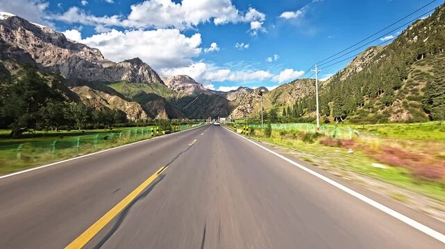 Driving a car through green valley. Beautiful Duku highway landscape in Xinjiang, China.