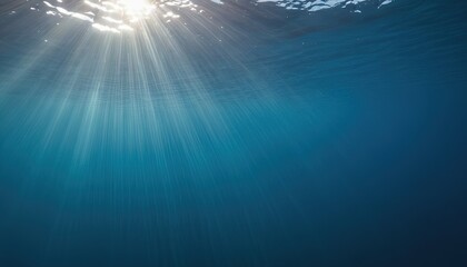 Sun rays illuminating the deep blue ocean water surface