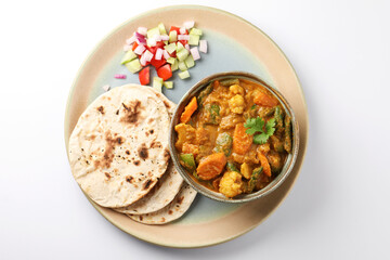 Indian traditional cuisine food mix veg curry made with carrots potatoes cauliflower beans and bell peppers with tandoori roti