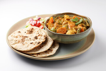 Indian traditional cuisine food mix veg curry made with carrots potatoes cauliflower beans and bell peppers with tandoori roti