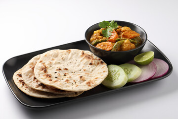 Indian traditional cuisine food mix veg curry made with carrots potatoes cauliflower beans and bell peppers with tandoori roti