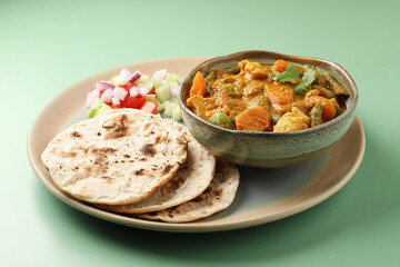 Indian traditional cuisine food mix veg curry made with carrots potatoes cauliflower beans and bell peppers with tandoori roti