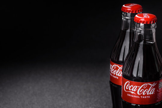 Nikopol, Dnepropetrovsk region Ukraine - April 24 2025: A bottle of chilled coca cola with drops of water on a black background