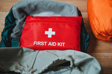 A wellprepared first aid kit is thoughtfully packed inside a durable backpack, which rests on a...