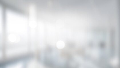 Blurred interior view of a bright office space with large windows. Professional photos for backgrounds for text, banners, posters, and web displays.