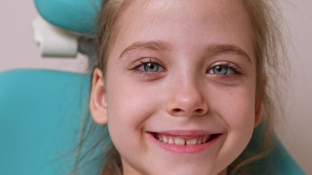 Beautiful white healthy baby teeth. Happy little girl smiles. Milk teeth close-up. High quality footage