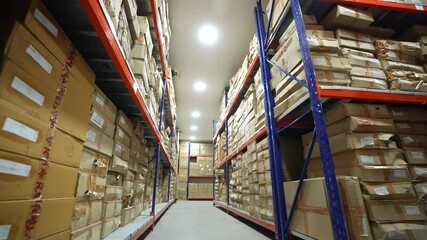 carton boxes in warehouse area cleanroom with colored racks for storage and epoxy flooring in a pharmaceutical manufacturing factory for active pharma ingredients, speciality chemicals, cardboard box