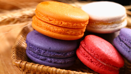 Macarons in a basket on a wooden background