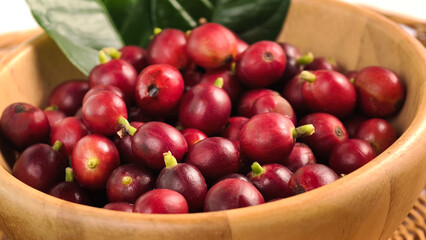 Red ripe coffee in a wooden bowl