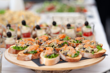 Gourmet Appetizers on a Wooden Plate at an Elegant Buffet Wedding Event