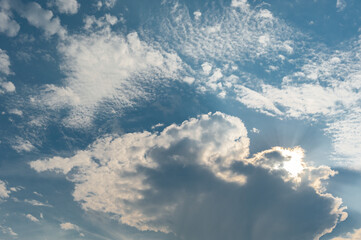 Dramatic Sky with Sun Rays and Fluffy White Clouds at Daytime