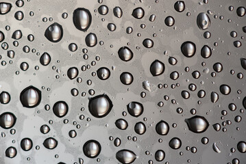 Close-Up of Water Droplets on a Smooth Transparent Surface