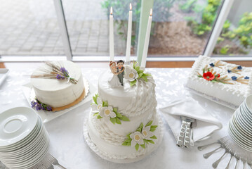 Elegant Wedding Cake on Decorated Table With White Floral Accents