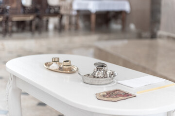 White Table with Religious Baptism Christening Rituals Items in Church Environment