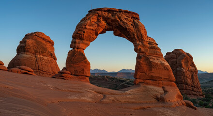 Natural sandstone arch formation against blue sky at golden hour. Geological wonder landmark. Erosion-created monument. attraction. Environmental conservation site. Desert landscape. Travel