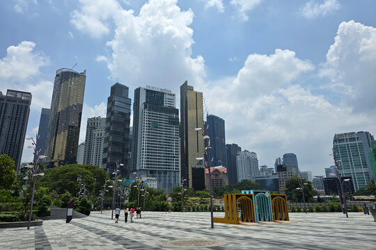 Kuala Lumpur, Malaysia &ndash; Mar 30, 2025: A scenic view of Raintree Plaza in the Tun Razak Exchange (TRX) featuring towering skyscrapers, modern art installations, and people enjoying the open space.