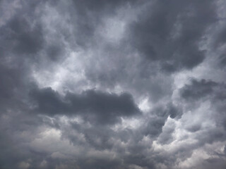 Storm clouds over field, tornadic supercell, extreme weather, dangerous storm. Dramatic dark storm rain clouds black sky background. Dark thunderstorm clouds rainy atmosphere. High resolution