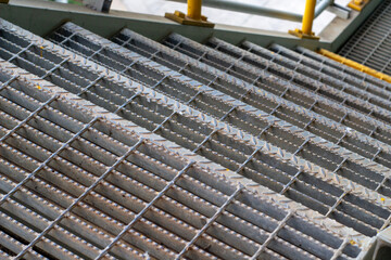 Metal grate stairs. Industrial architecture detail. Safety flooring