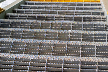 Metal grate stairs. Industrial architecture detail. Safety flooring