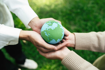 World Environment Day, hands holding earth globe to protect and save clean planet, Environmental care for sustainable.Green Business Save Earth and Eco Friendly. ESG and CSR concept to net zero