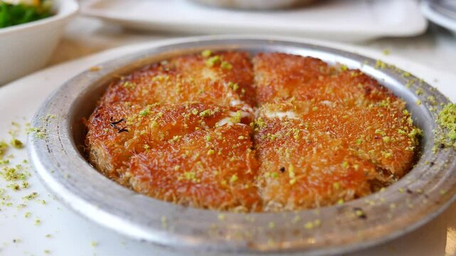  kunefe a traditional Turkish sherbet dessert in a copper bowl