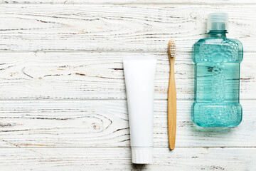 Mouthwash and other oral hygiene products on colored table top view with copy space. Flat lay....