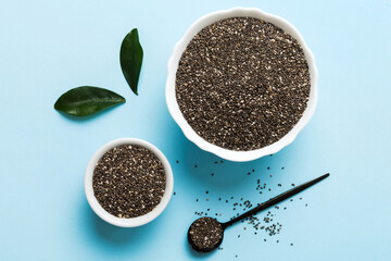 Chia seeds in bowl and spoon on colored background. Healthy Salvia hispanica in small bowl. Healthy superfood