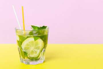 Mojito summer refreshing cocktail with ice and mint. mojito cocktail with lime, lemon and mint in a tall glass with a stick
