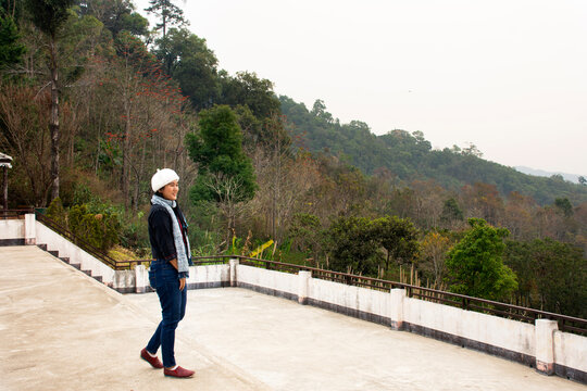 Travelers thai women wearing coat jacket travel visit and portrait take photo at Doi Kiew Lom Scenic Point in Pang Ma Pha hill valley village city while PM 2.5 Dust situation at Mae Hong Son, Thailand