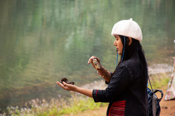 Travelers thai women journey travel visit and take photo between tour at Pang Ung lake in Pang Oung forest park or Switzerland of Thailand  in Chinese village Ban Rak Thai in Mae Hong Son, Thailand