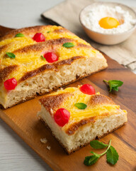 Coca San Juan, a traditional Catalan dessert similar to brioche with pastry cream and candied fruit. Top view table.