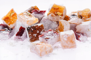 Sweet food Turkish delight, assorted rahat locum in form of cubes with nuts and powdered sugar, traditional food, on white background