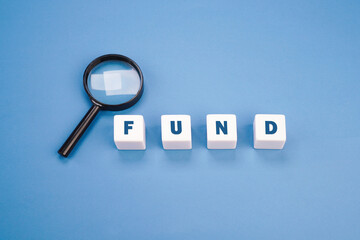 White blocks with fund word and magnifying glass in business concept
